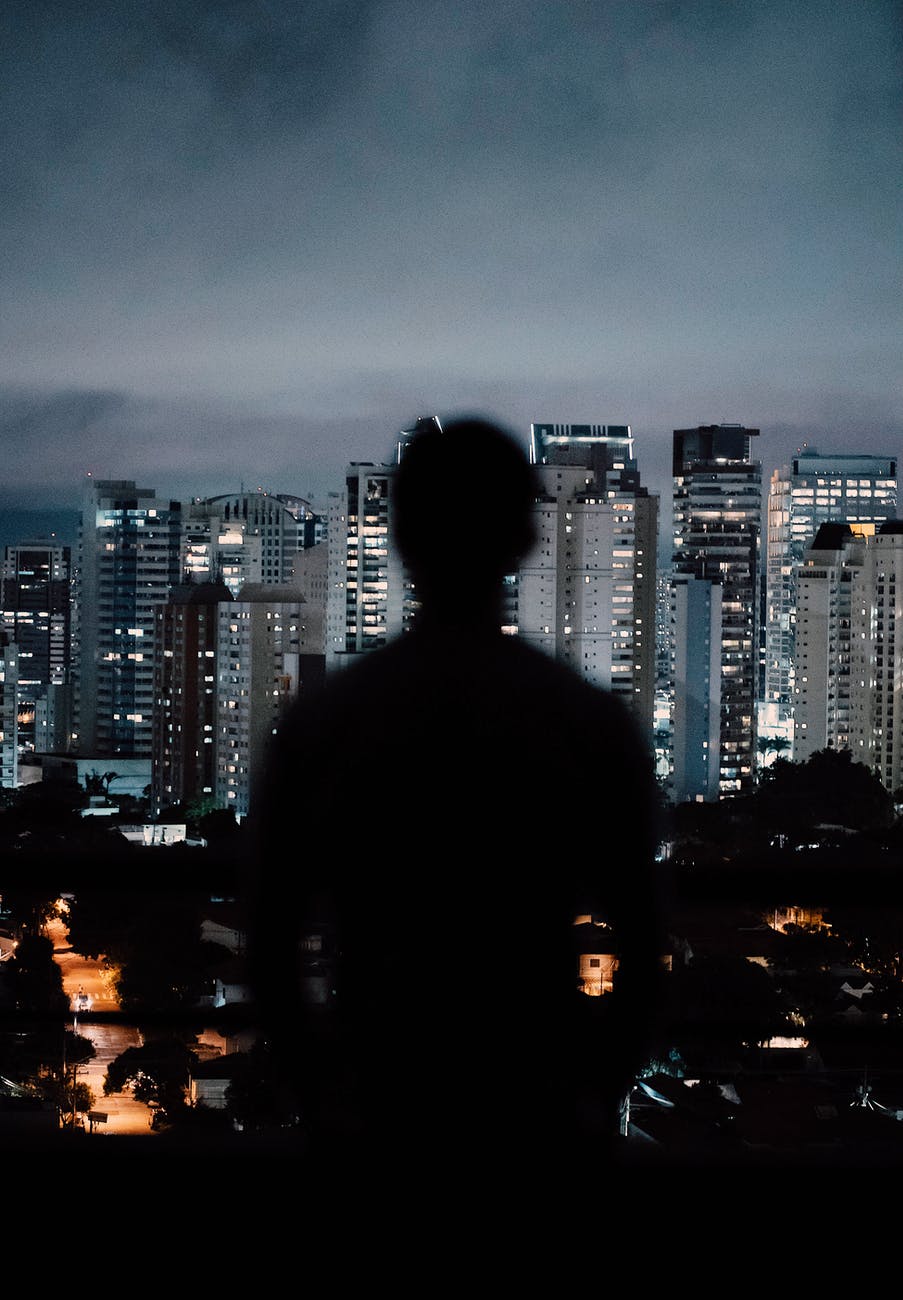 blurred person standing on background of skyscrapers